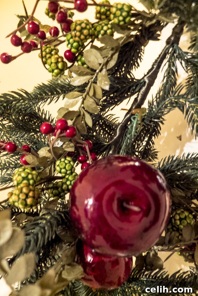 Balsam Hill: Crafting Unforgettable Christmas Memories 6 Intricate details in the Balsam Hill Norway Spruce festive garland, showcasing realistic berries and foliage