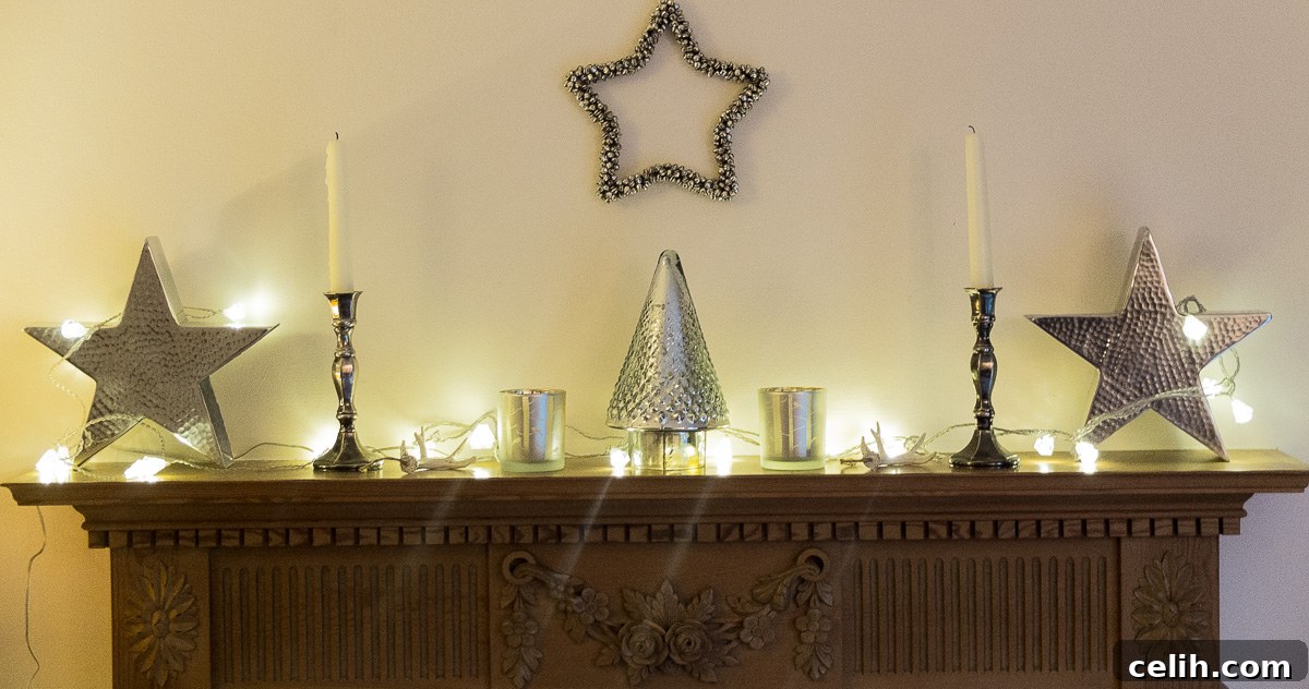 Minimal Christmas mantlepiece styling with hammered metal stars and a jingle bell star
