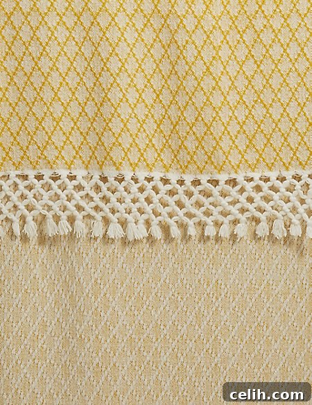 Sophisticated Elsie tassel throw from M&S, featuring a geometric diamond design and multi-tier tassel trim, available in ochre.