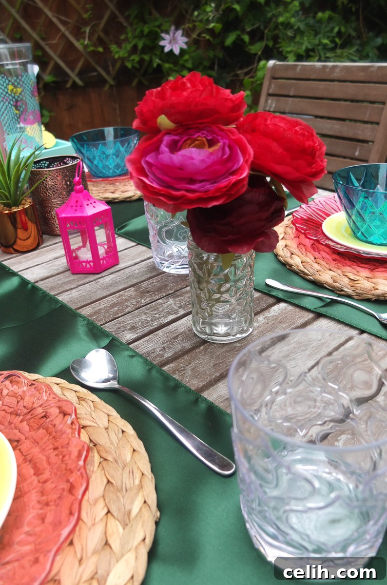 Dine outside in style with a bohemian brights pink and green colour scheme, illuminated by ambient lighting.