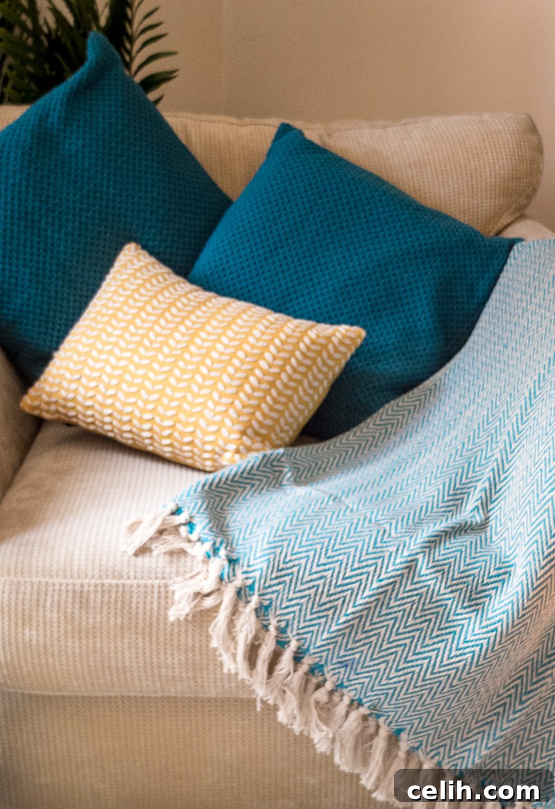 Elevate your living room chairs with vibrant teal textured cushion covers for an autumn refresh