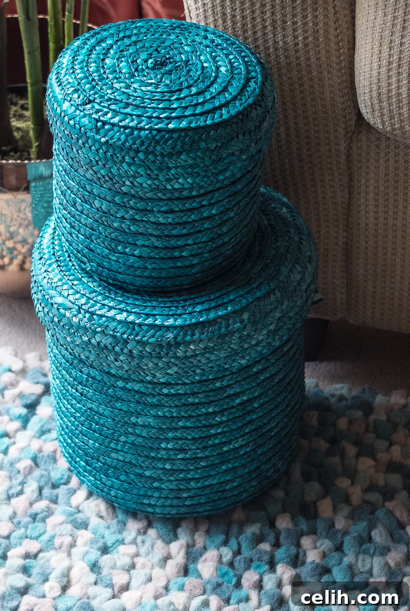 Conquer clutter in style with this elegant set of two lidded wicker storage baskets, perfect for any room