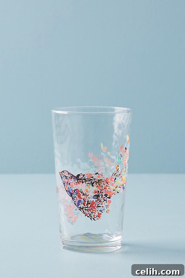 Exclusive juice glass featuring a design by artist Kiana Mosley, bursting with vibrant colors and joyful patterns.