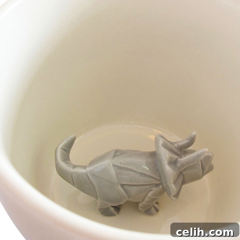Assortment of dinosaur themed home decor items including egg cups and various ornaments.