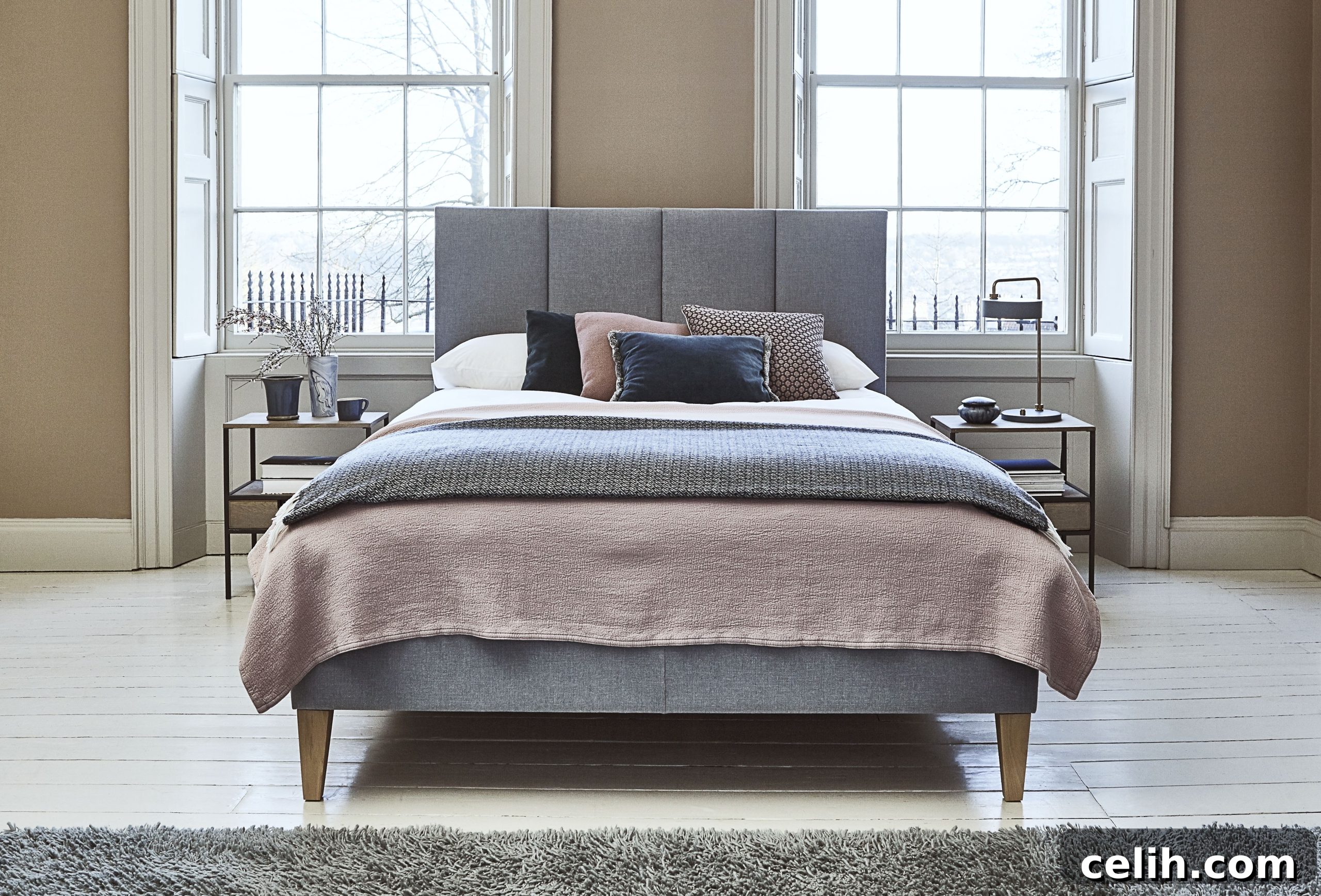 Stylish bedroom decor featuring a grey bed and pink and grey bedding, showcasing a sophisticated color palette