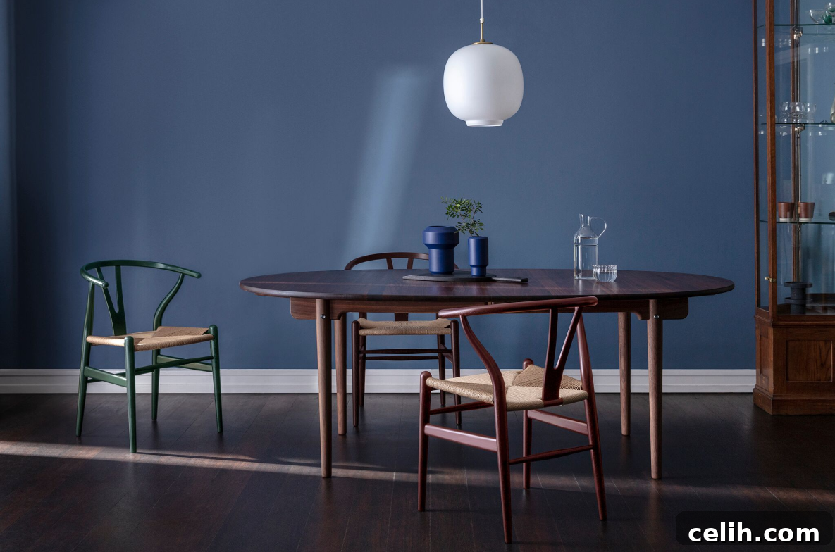 The elegant Hans J. Wegner Wishbone Chair, showcasing its distinctive Y-shaped back and hand-woven seat in a classic interior setting.