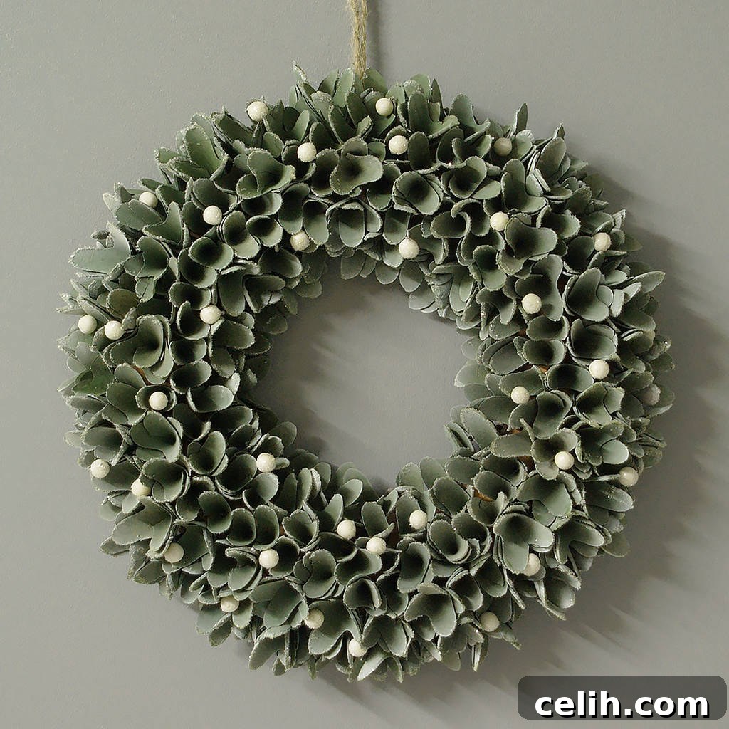 Deck the Halls with Amazing Christmas Wreath Hanging Ideas 8 Elegant faux mistletoe door wreath, featuring closely bunched artificial mistletoe leaves and realistic white berries. A sophisticated and smart seasonal decoration perfect for a welcoming front door during Christmas.