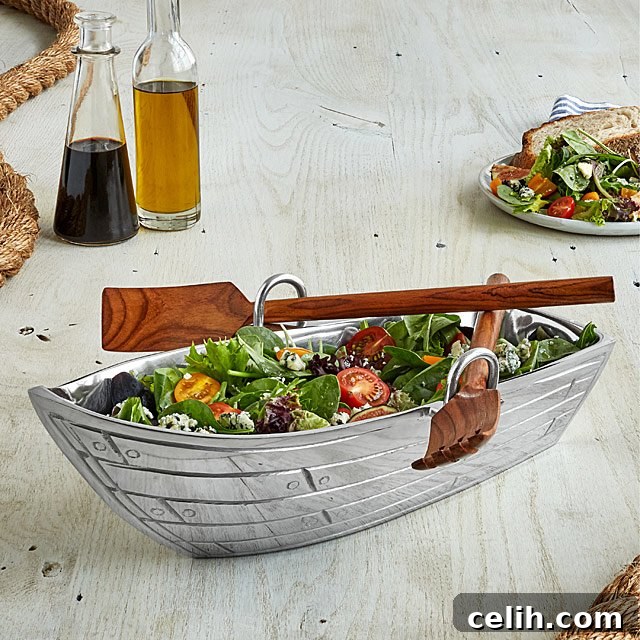 Charming aluminium row boat serving bowl with wooden oar utensils, perfect for unique table settings and adding a whimsical touch to your serveware collection.