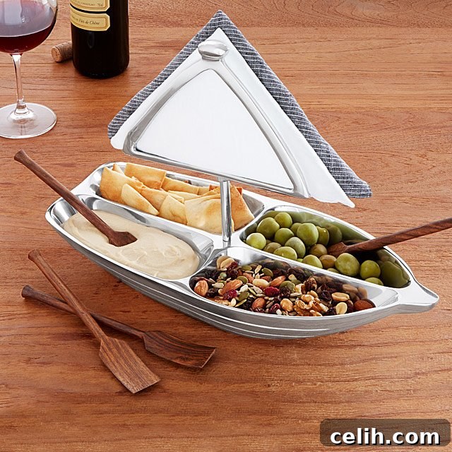 Multi-sectional rowboat serving bowl with an integrated napkin holder and oar-like spoons, a truly unique and practical quirky serveware idea for parties.