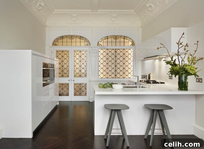 Kitchen Design: Crafting the Heart of Your Home 3 Family friendly white kitchen design with breakfast bar seating