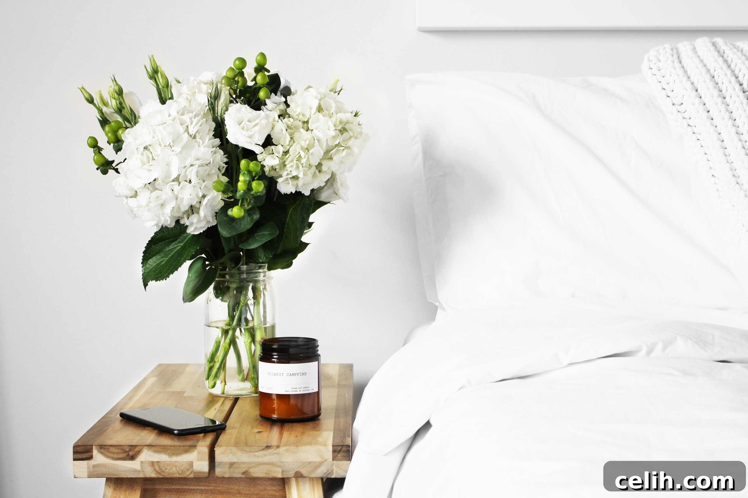 Create Your Sleep Sanctuary 5 Calming bedroom with white bedding and a low impact bedside table