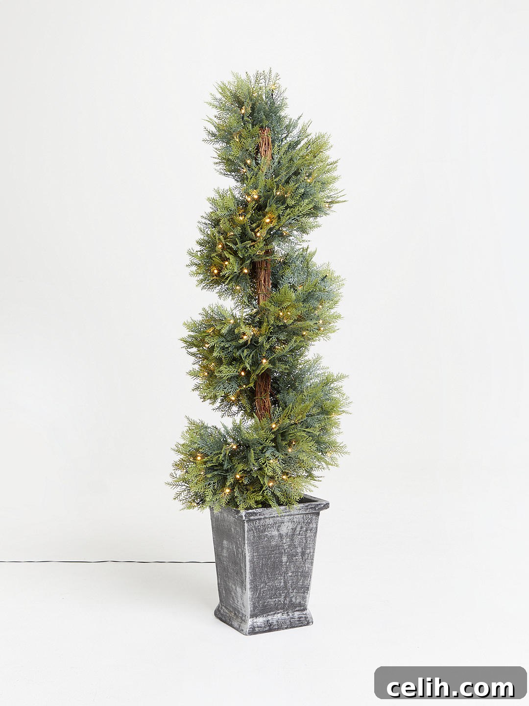 Unusual pre-lit potted topiary Christmas tree for indoor or outdoor use, adding a unique touch to festive decor
