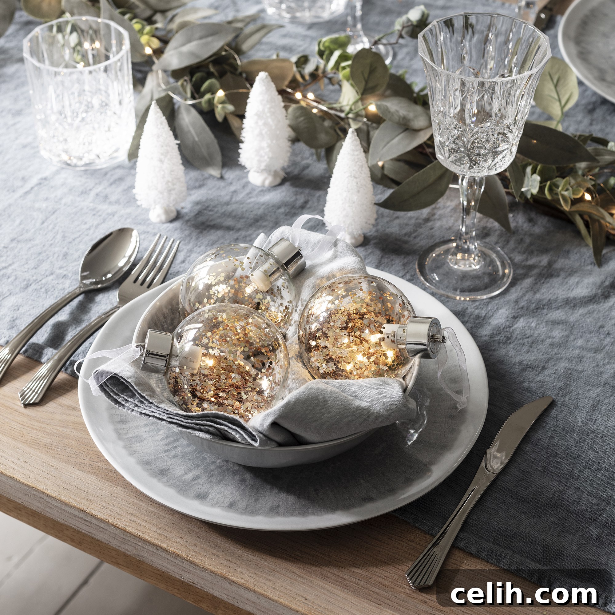 Rose gold metallic bauble lights illuminating a festive Christmas dining table