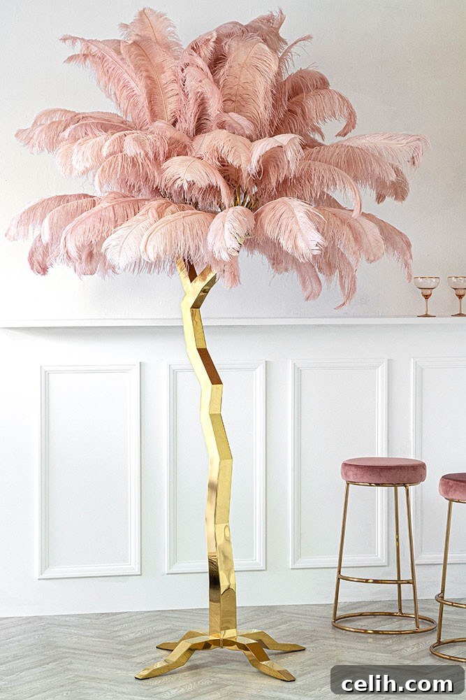 Luxurious pink ostrich feather tree sculpture with a gold base, a flamboyant floor-standing art piece for statement-making interiors.