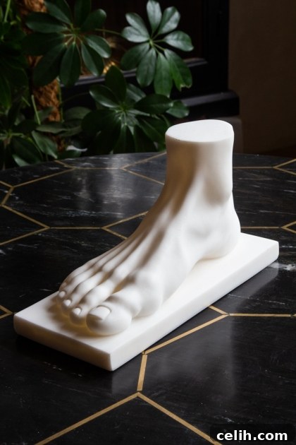 Super eccentric white foot statue, designed to replicate antique marble, made from resin and marble powder for a conversation-starting display.