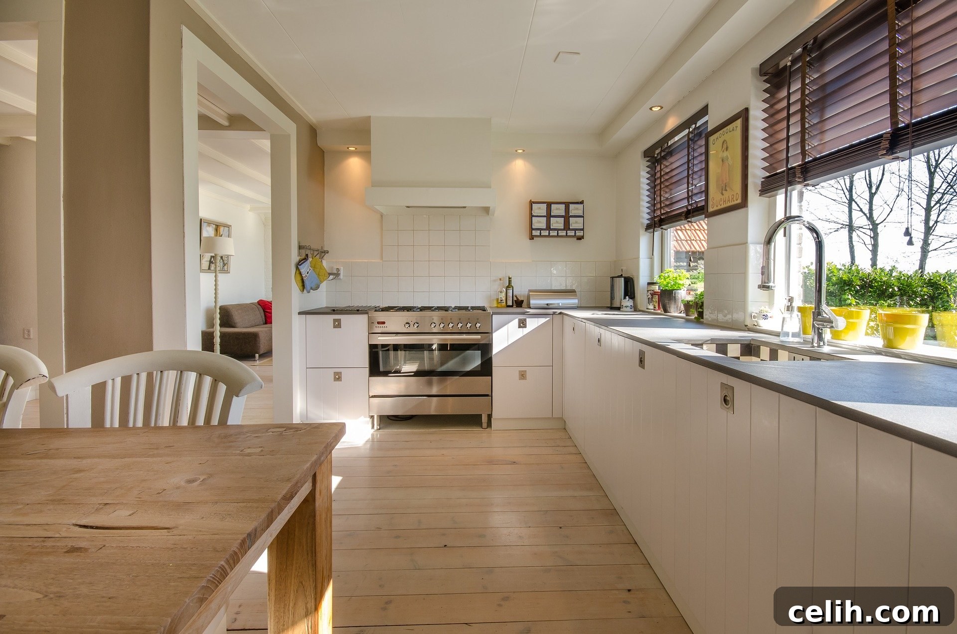 Modern kitchen with white painted cabinets, updated hardware, and a stylish glass splashback, demonstrating a budget-friendly renovation.