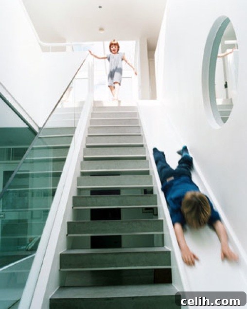 Sleek straight staircase with a fun slide for kids and adults