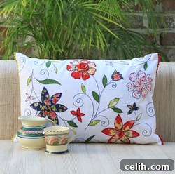 Contemporary Indian white flower cushion with vintage prints appliqued onto cotton canvas by Plum Chutney.