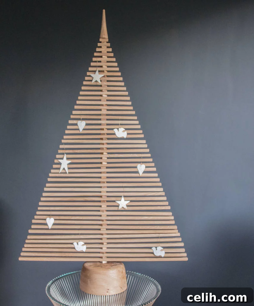 Beyond Traditional: 10 Stunning Modern Christmas Tree Designs 3 Wooden Christmas tree branches arranged in a spiral pattern, showcasing its versatility.