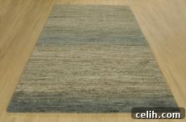 Close-up of a green and neutral gradient section of a hand-knotted Himali Shade rug, highlighting wool fibers