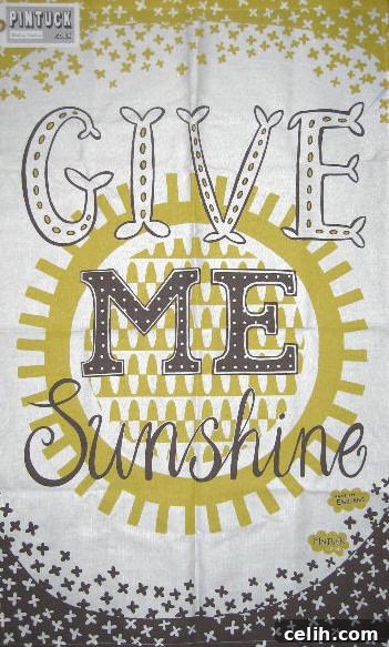 Cheerful yellow tea towel with a 'Give Me Sunshine' slogan